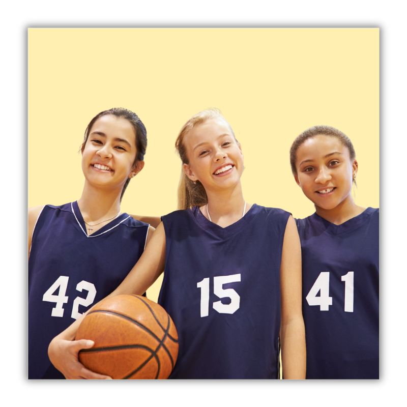 The image shows three girls in a gym playing basketball.