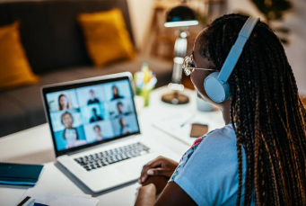 Black women doing a virtual meeting on her laptop