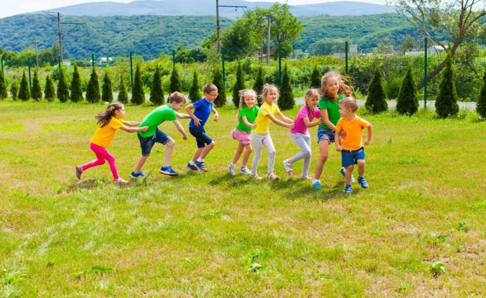 The photo is showing a group of children playing outdoors.