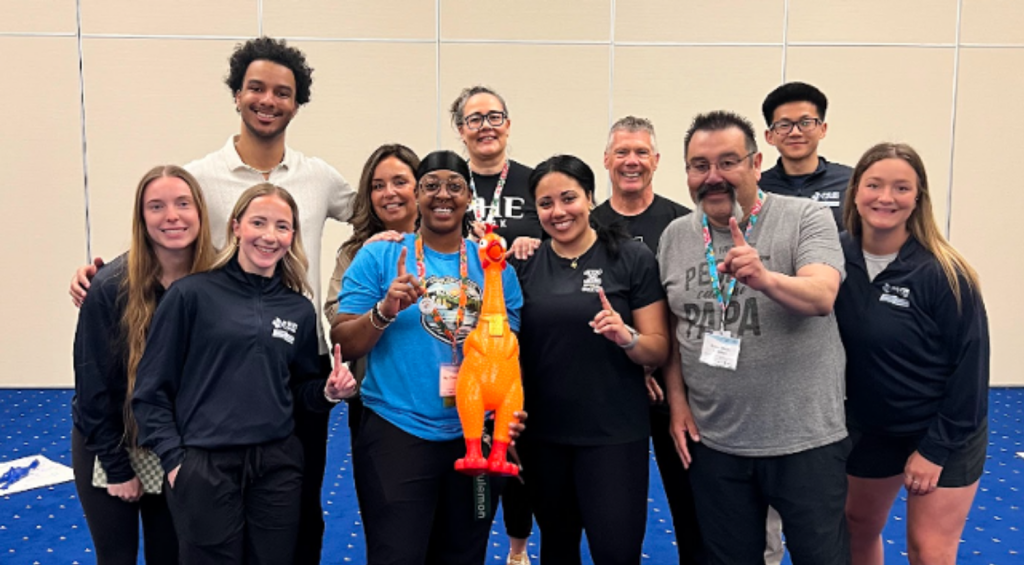 The UBC HOPE PHE Canada Student Chapter members presenting the winning purple team with the Rubber Chicken Trophy