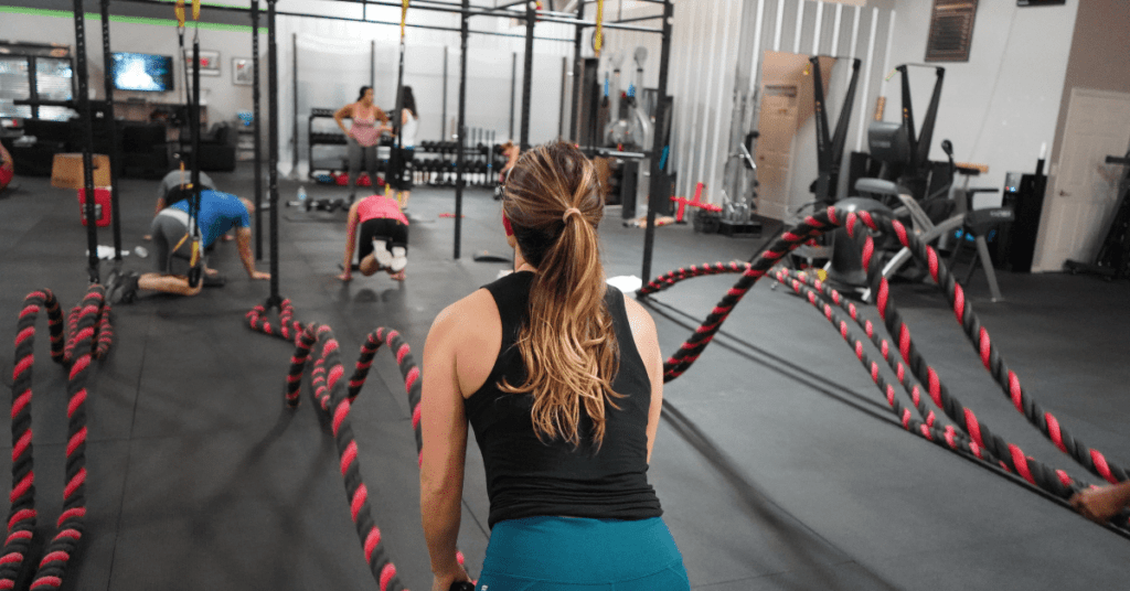 people working out in a weight room using ropes
