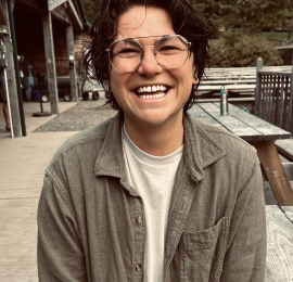 photo of kai Williamson wearing a green long sleeve with a white shirt underneath 