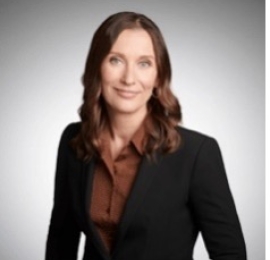 headshot of Jennifer wearing a black blazer and brown collared shirt. 