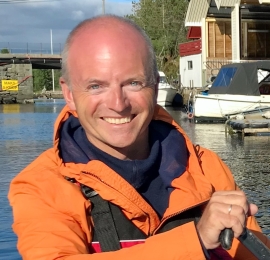 Torbjørn Lundhaug's profile photo shows a Caucasian man practicing an outdoor water sport, wearing a bright orange jacket.