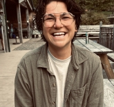 photo of kai Williamson wearing a green long sleeve with a white shirt underneath 