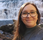 Alyce Casey's profile is showing that Alyce is in front of a waterfall smiling.