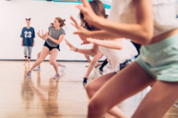 teenagers dancing on hardwood floor as a dance class in high school