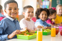 A group of kids enjoying the food in schools.